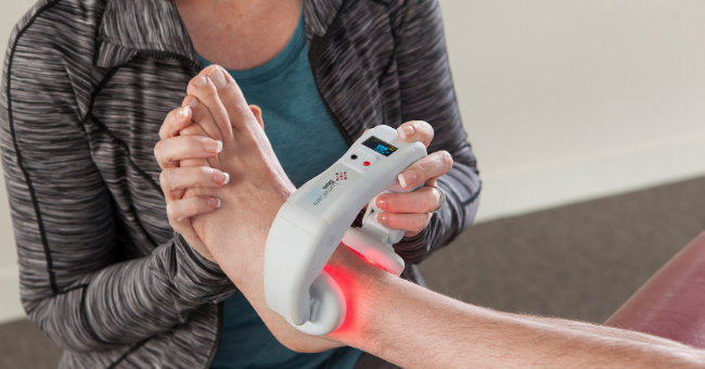 a female dr treating a patients ankle with the lumacare duo