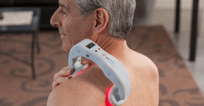 a man treating his shoulder pain with cold laser therapy