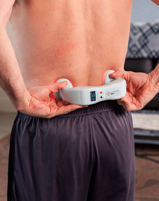 a man treating his back pain with the lumacare duo
