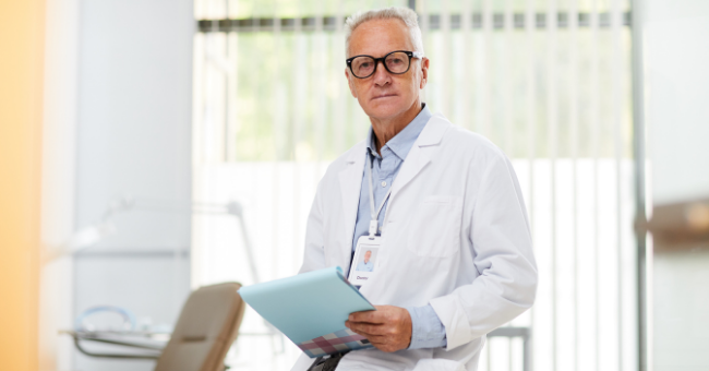 male dr holding a clipboard