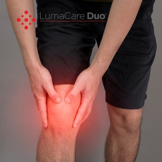 Sore knee needing cold laser therapy sports device